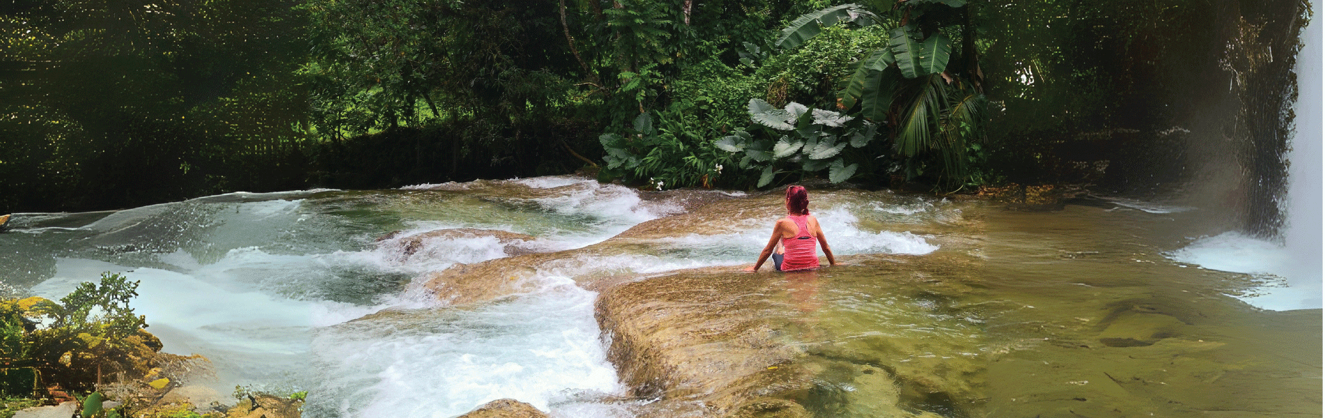 Benta River Falls, rivers in Negril, Cannabis Delivery Negril Image of a woman sititng at Benta Falls